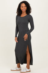 woman wearing a black ribbed long sleeve maxi dress with a side slit and white sneakers