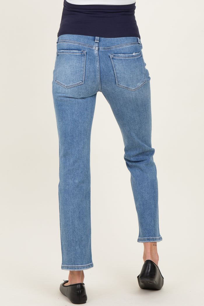 woman wearing light blue maternity jeans, viewed from the back, with a fitted waistline and straight leg style