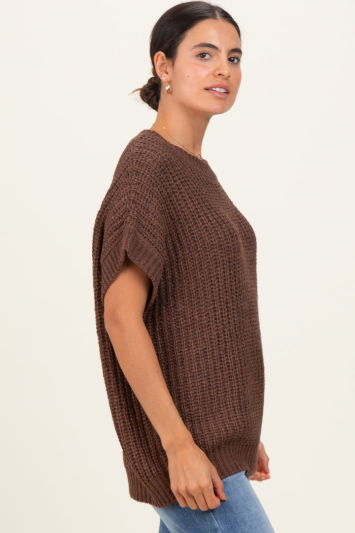 woman wearing a brown oversized knit sweater with short sleeves and a relaxed fit