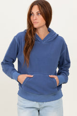 woman wearing a blue hoodie with a front pocket and a relaxed fit