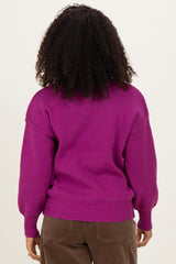 woman wearing a bright purple oversized sweater with puffed sleeves and ribbed hem, showing the back view