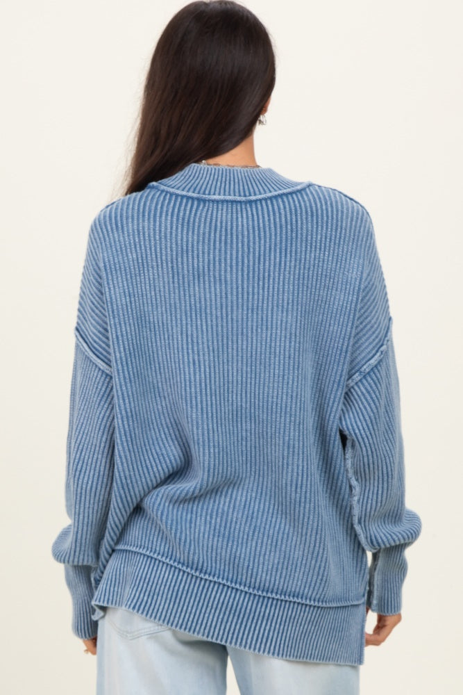 woman wearing a light blue oversized ribbed sweater with a round neckline and slouchy fit