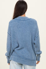 woman wearing a light blue oversized ribbed sweater with a round neckline and slouchy fit