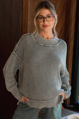 woman wearing a gray and white striped maternity sweater with a relaxed fit and a high neckline