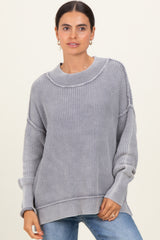 woman wearing a cozy gray ribbed sweater with a relaxed fit and dropped shoulders
