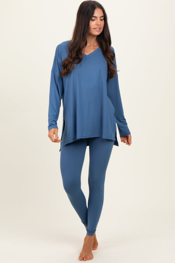 woman wearing a blue long sleeve v-neck top with side slits and matching fitted leggings