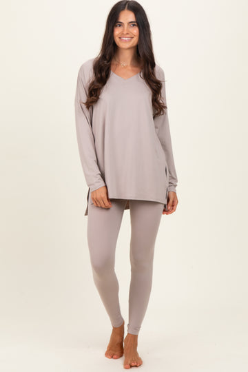woman wearing a light taupe long sleeve v-neck top and matching leggings