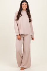 woman wearing a light beige ribbed long sleeve top and matching wide-leg pants