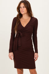 woman wearing a chocolate brown long sleeve wrap dress with a tie at the waist and a v-neckline