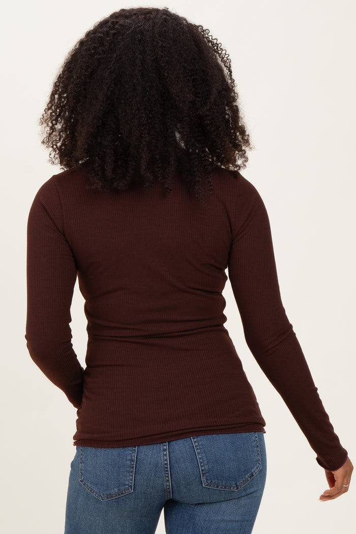 woman wearing a fitted brown long sleeve top with a ribbed texture, viewed from the back