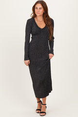 woman wearing a black long sleeve maxi dress with a v-neck and shimmery fabric