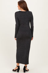woman wearing a black sparkly long sleeve maxi dress with a fitted silhouette and back view
