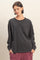 woman wearing a dark gray long sleeve shirt with a front pocket and relaxed fit