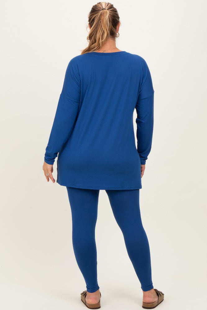 woman wearing a long sleeve blue maternity top with a loose fit and matching leggings, showing a baby bump