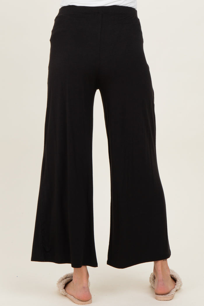woman wearing black maternity wide-leg pants, view from the back