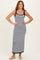 woman wearing a navy and white striped maxi dress with tie straps and a fitted silhouette