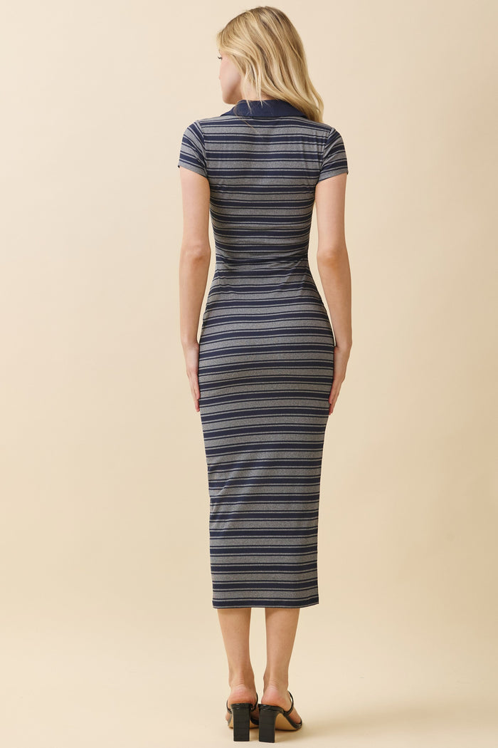 woman wearing a fitted navy and white striped midi dress with short sleeves and a collar, viewed from the back