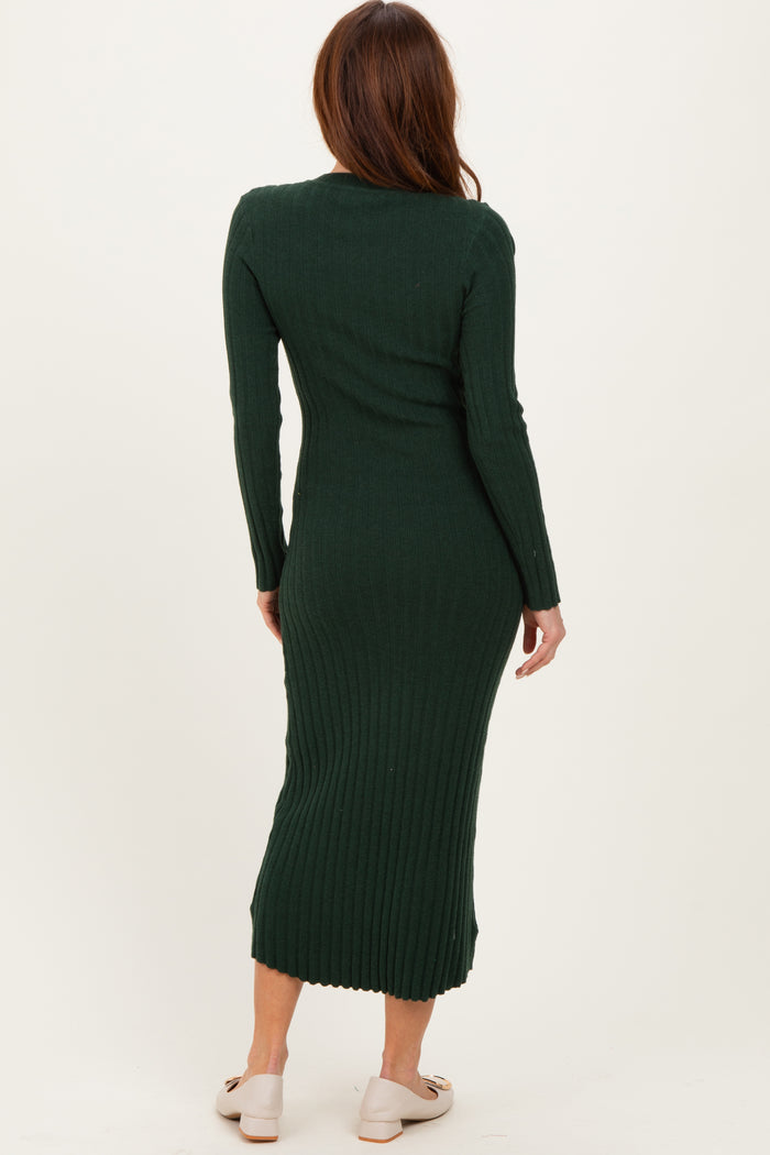 woman wearing a dark green ribbed knit midi dress with long sleeves, viewed from the back