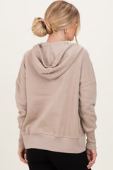 woman wearing a beige oversized hoodie with a back hoodie and ribbed cuffs