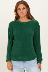 woman wearing a green long sleeve textured sweater with a relaxed fit and round neckline
