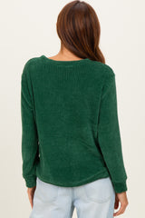 woman wearing a green ribbed long sleeve top, showing the back view with relaxed fit and soft texture