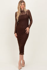 woman wearing a brown lace long sleeve midi dress with a fitted silhouette and a sheer bodice
