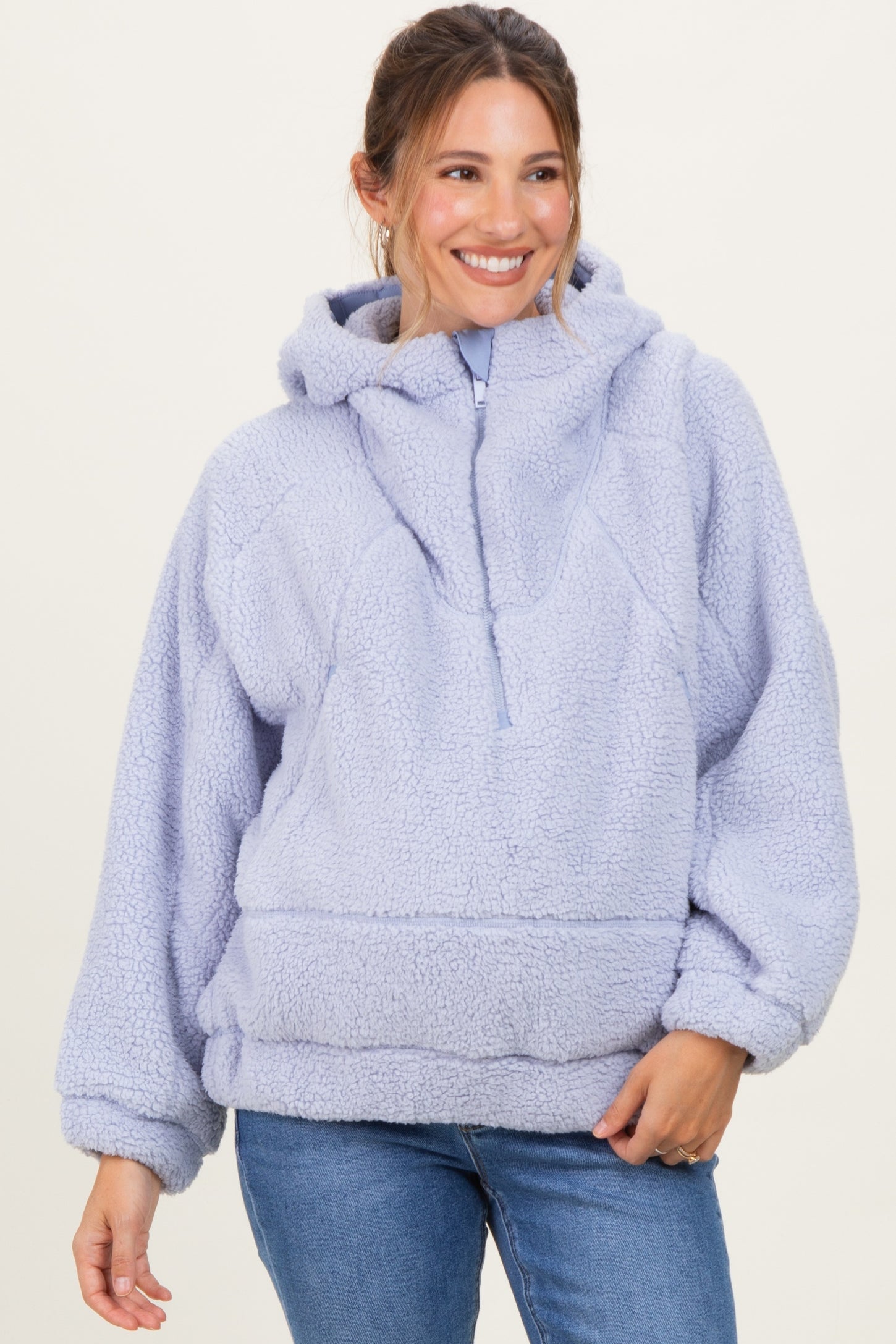 woman wearing a lavender maternity pullover hoodie with a cozy fleece texture and a front pocket