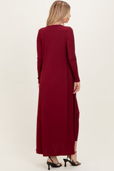woman wearing a long burgundy ribbed maxi dress with long sleeves, viewed from the back