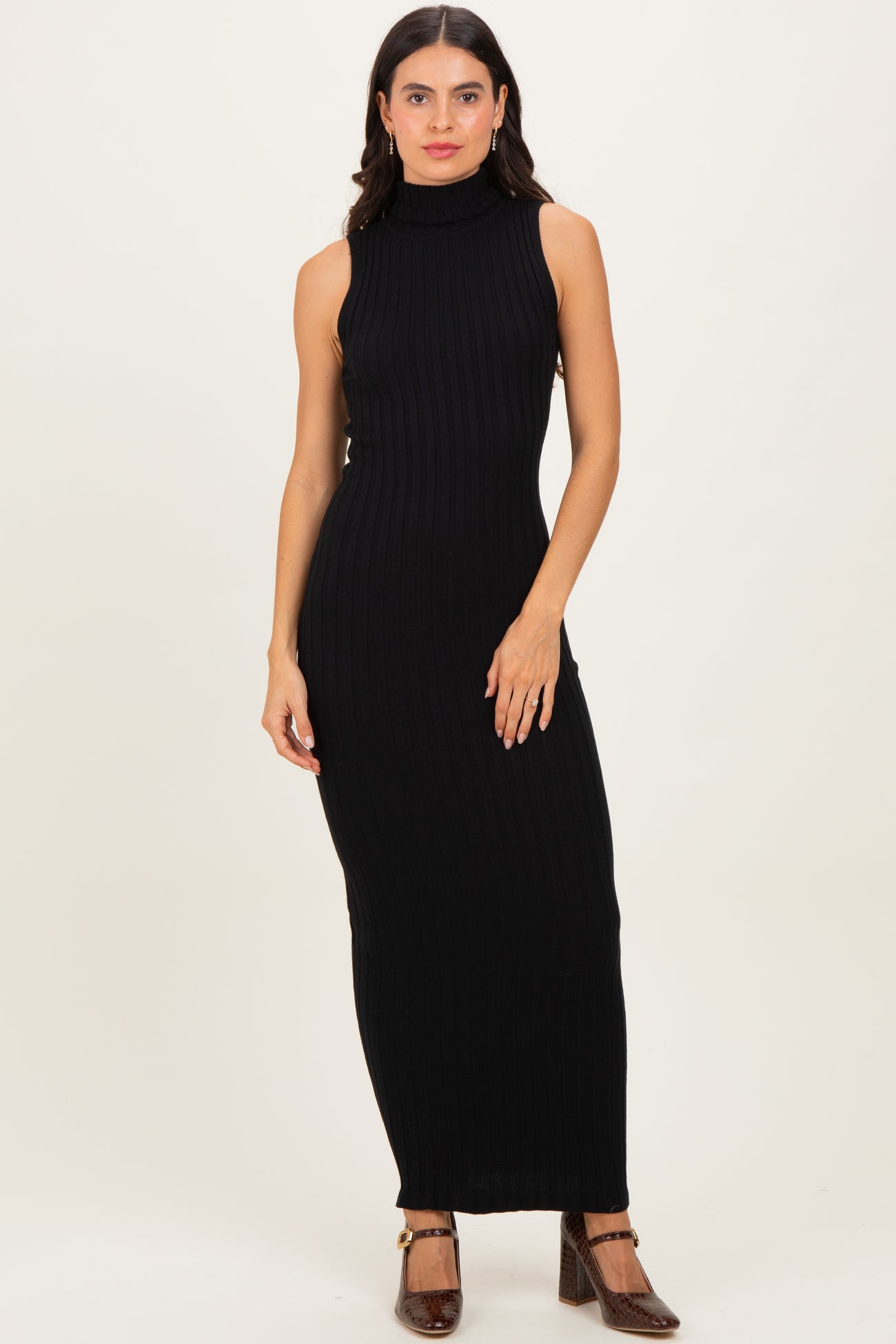 woman wearing a black sleeveless ribbed maxi dress with a high neckline
