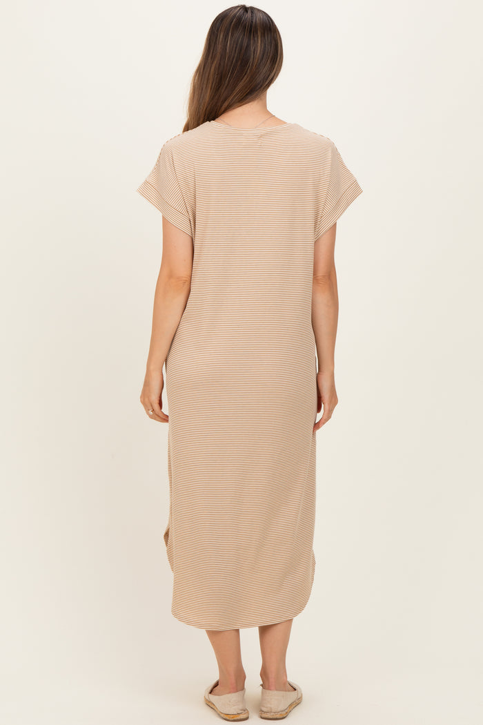woman wearing a beige maternity wrap dress with short sleeves and side slits, shown from the back