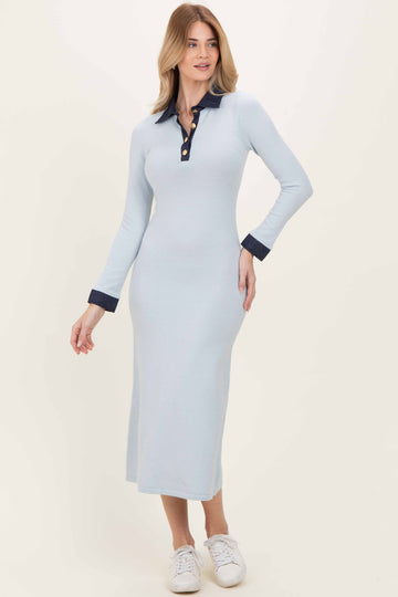 woman wearing a light blue long sleeve ribbed midi dress with a navy collar and buttons, paired with white sneakers