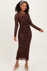 woman wearing a brown long sleeve ruched midi dress with floral lace details and styled with a headband