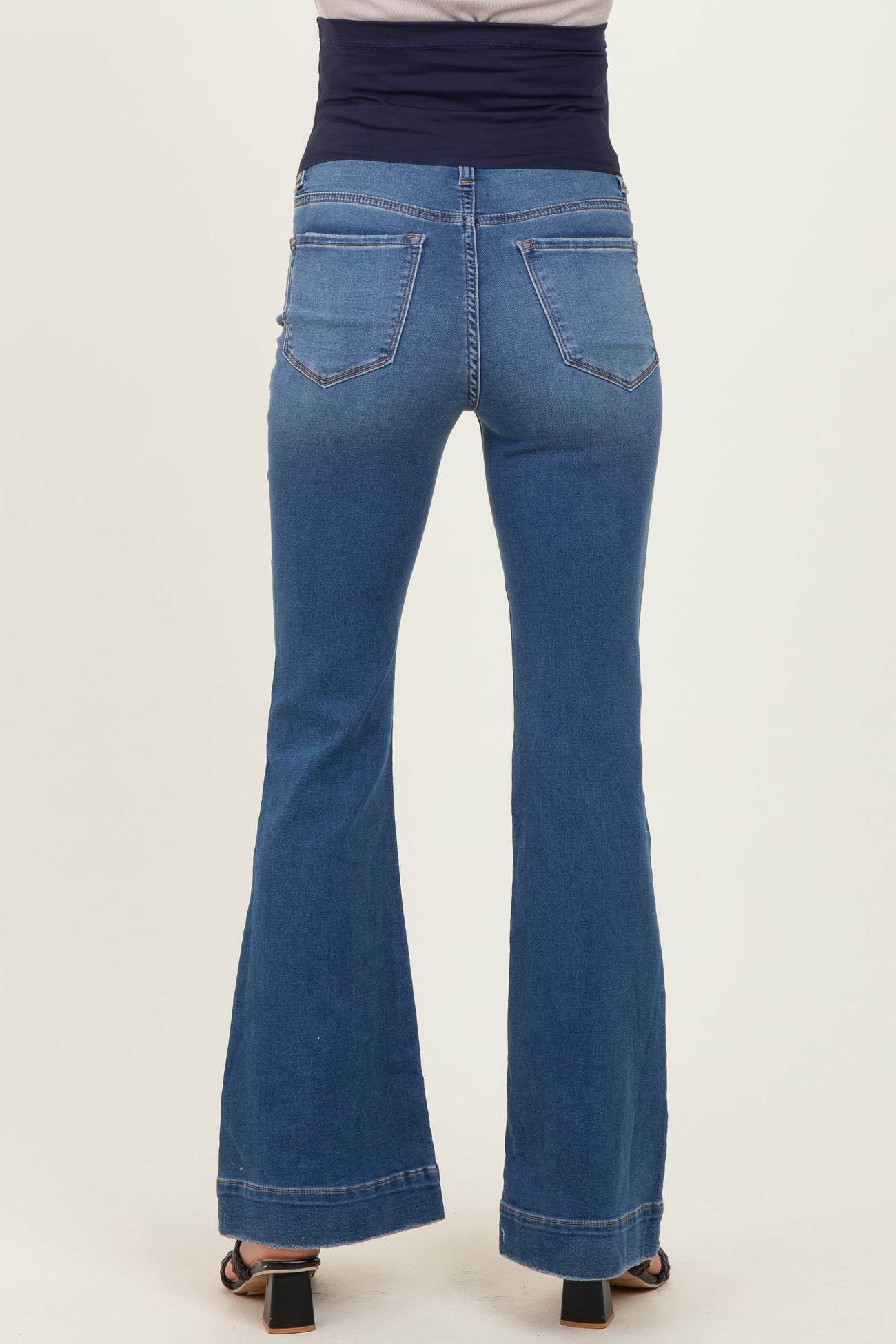 maternity wear blue flared jeans shown from the back with a comfortable waistband