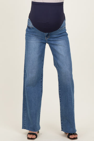 woman wearing a pair of light wash maternity jeans with a black over-the-bump panel and a relaxed fit