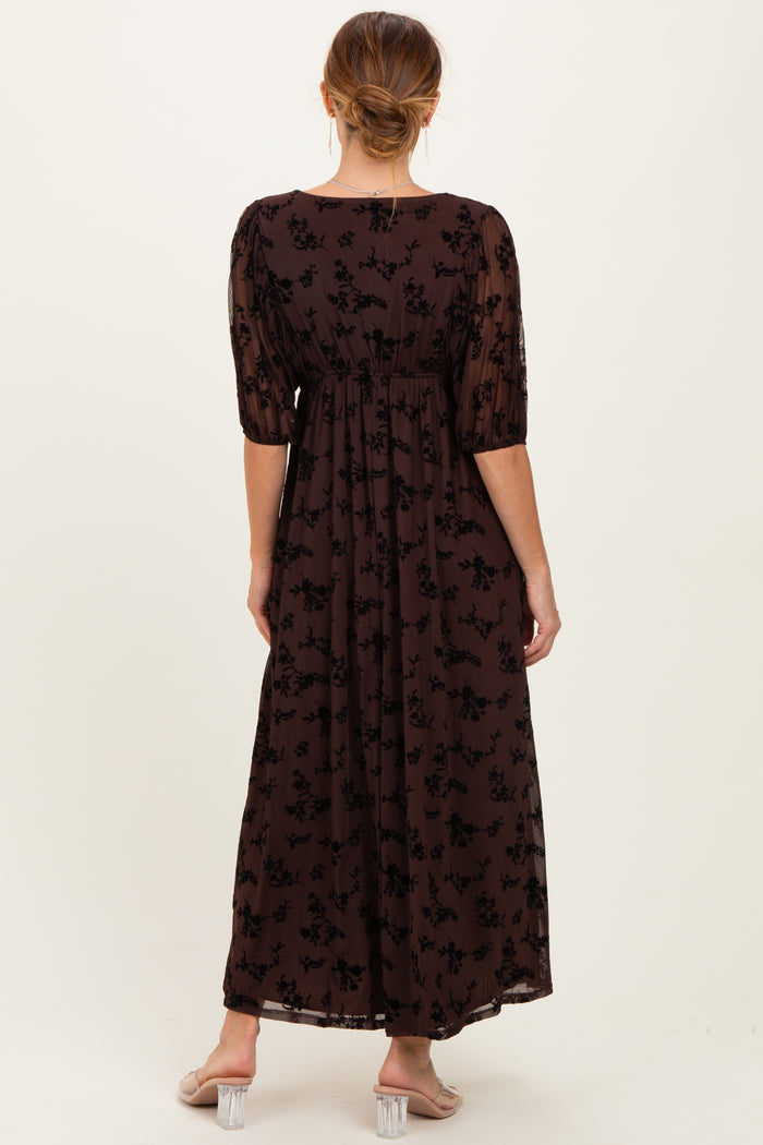 woman wearing a brown floral maxi dress with puff sleeves, viewed from the back