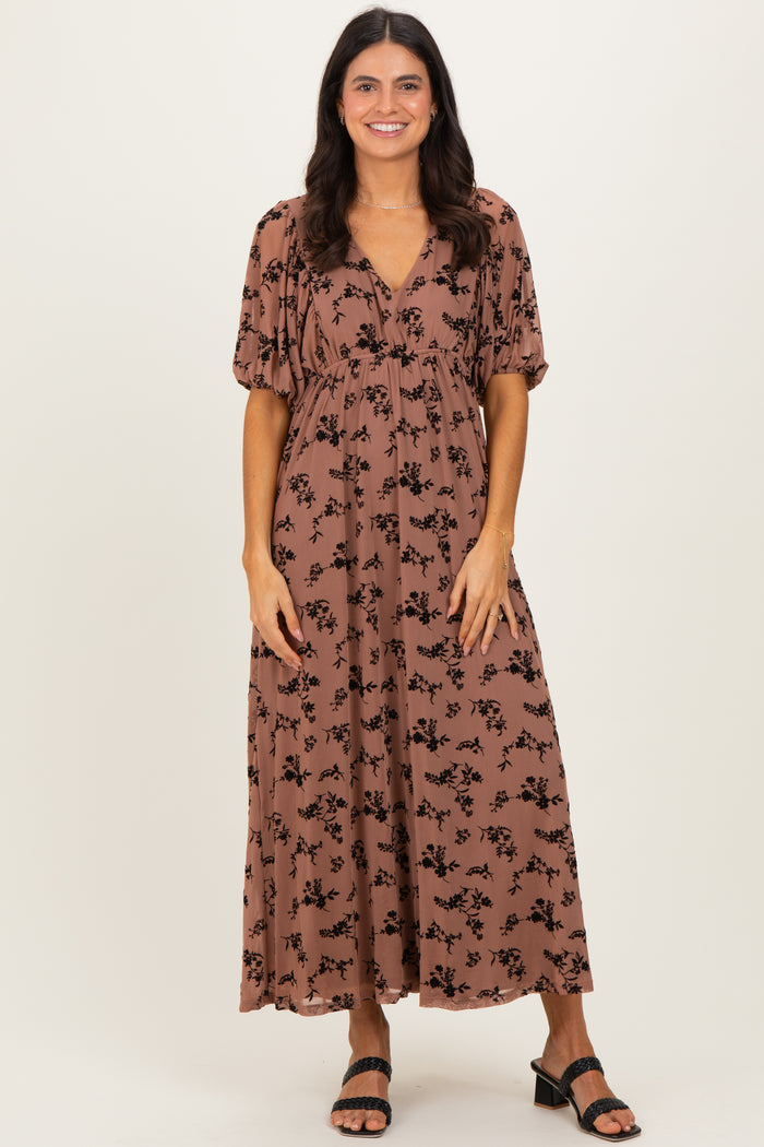 woman wearing a brown floral maxi dress with puff sleeves and a v-neckline