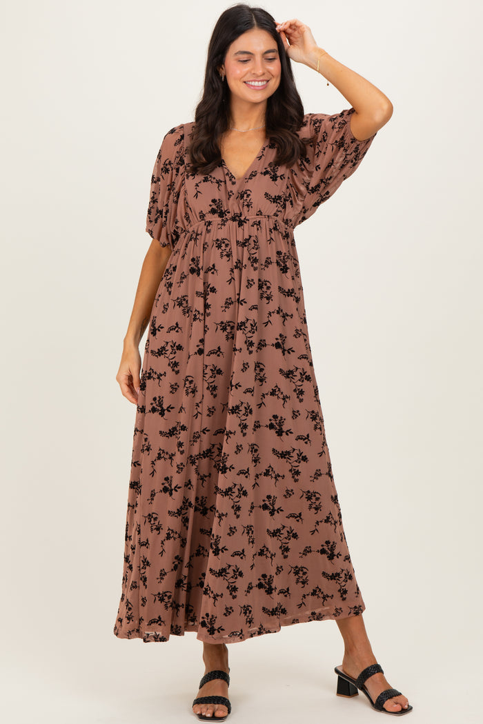 woman wearing a brown floral maxi dress with short sleeves and a v-neckline