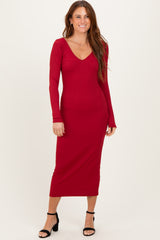 woman wearing a red ribbed long sleeve midi dress with a v-neckline and fitted silhouette