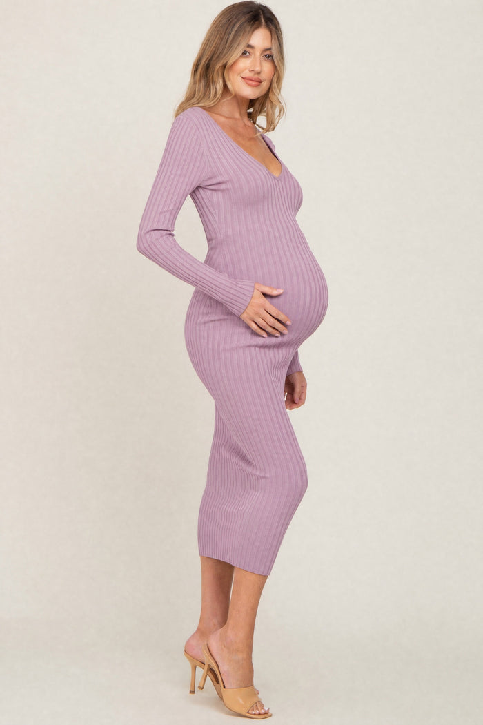woman wearing a lavender ribbed maternity dress with a v-neck and long sleeves, showing a visible baby bump
