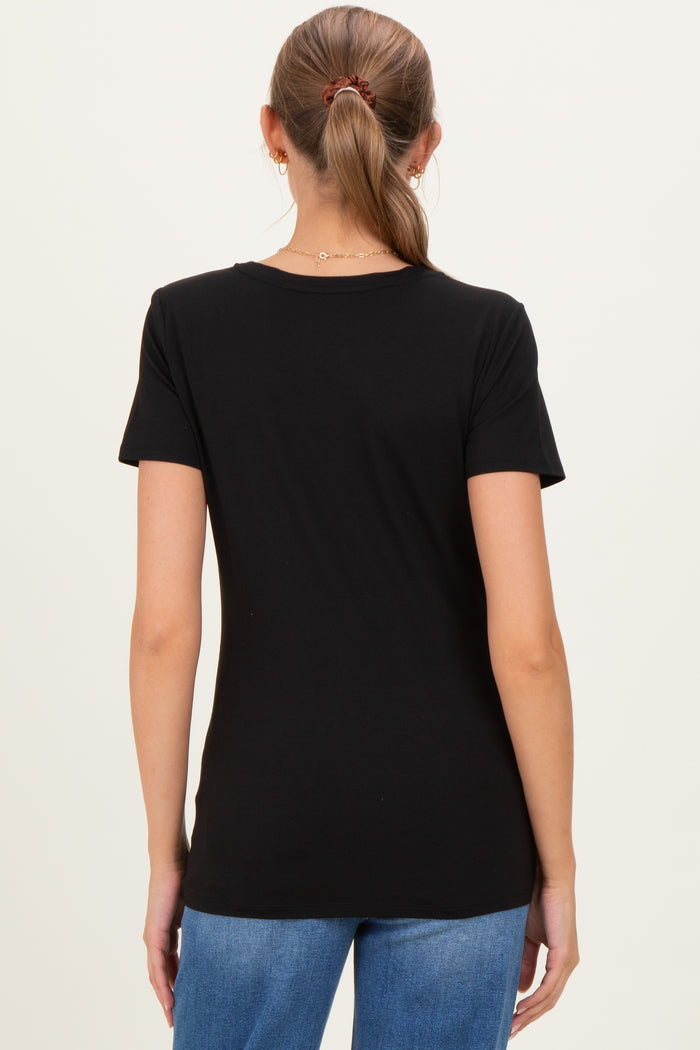 woman wearing a black short sleeve maternity top, seen from the back with her hair pulled back