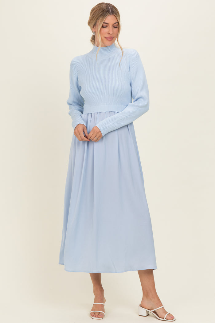 woman wearing a light blue cropped sweater and a flowing light blue maxi skirt