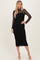 woman wearing a black lace midi dress with long sleeves and a fitted silhouette, standing gracefully