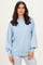 woman wearing a light blue oversized sweater with balloon sleeves and a matching headband