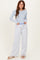 woman wearing a light blue long sleeve top and grey wide-leg sweatpants with an adjustable waistband