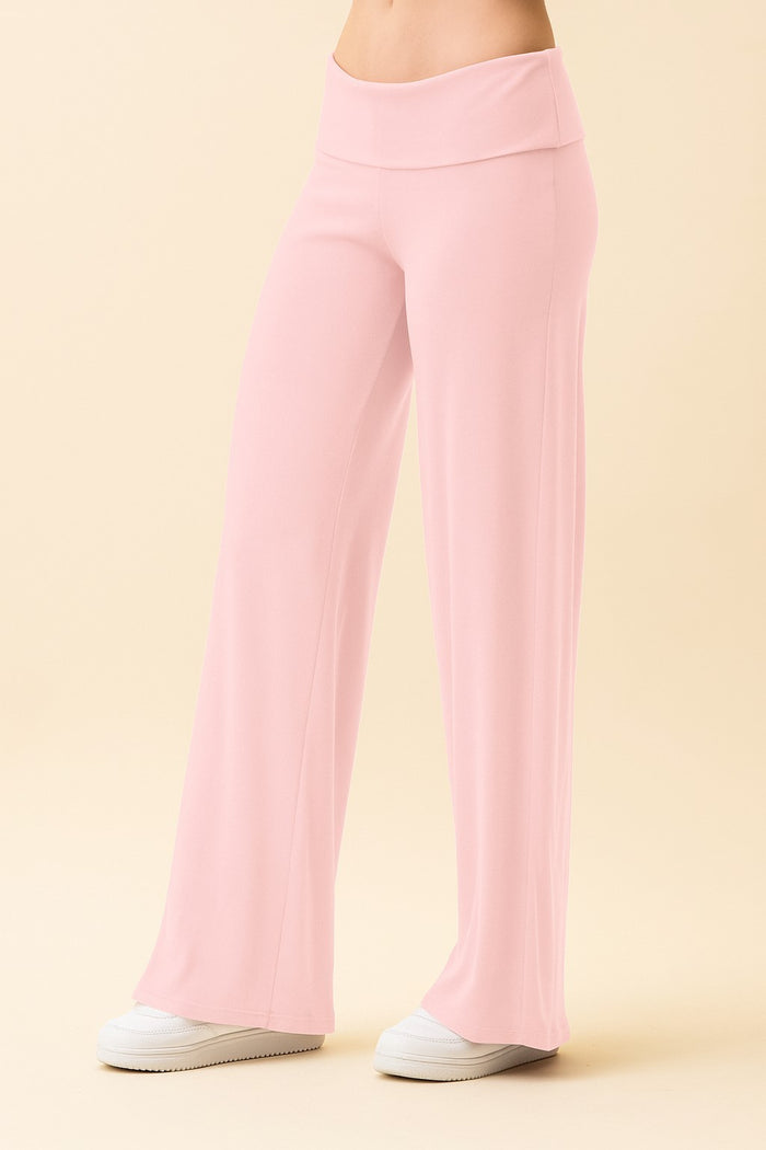 woman wearing light pink wide-leg lounge pants with an elastic waistband