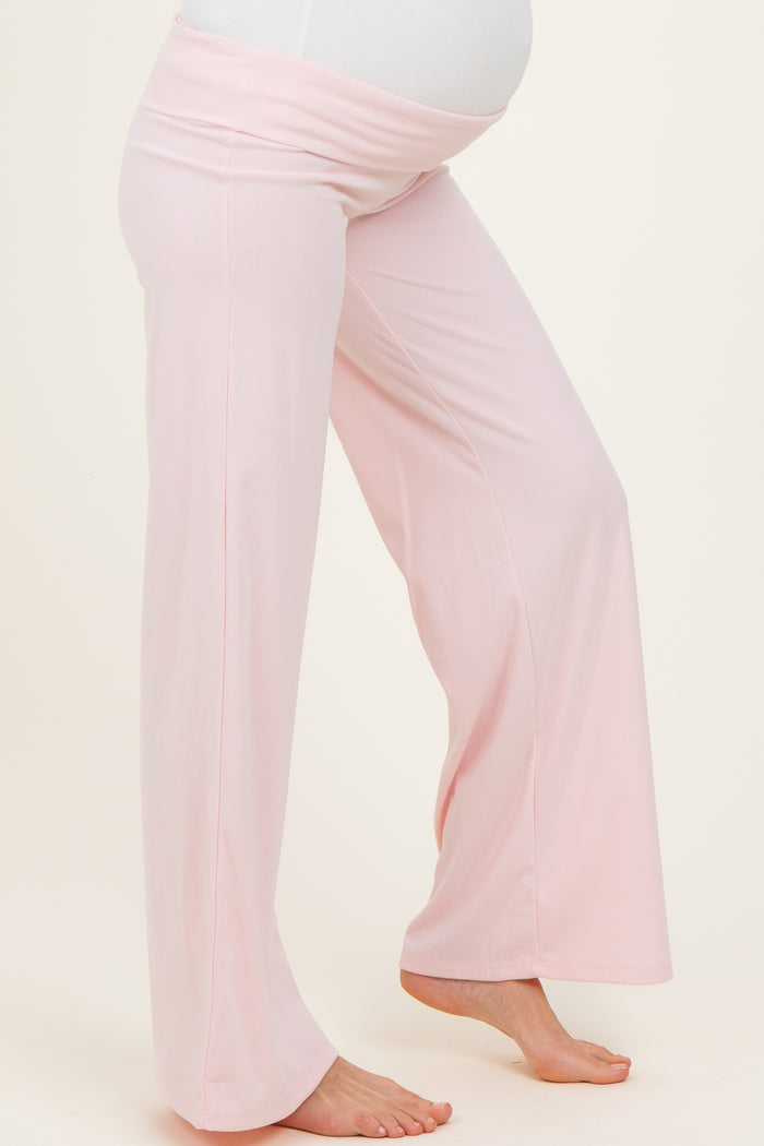 maternity wear light pink wide-leg maternity pants with a stretchy waistband and a visible baby bump