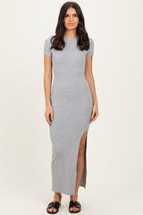 woman wearing a gray ribbed maxi dress with short sleeves and a side slit, standing on a neutral background