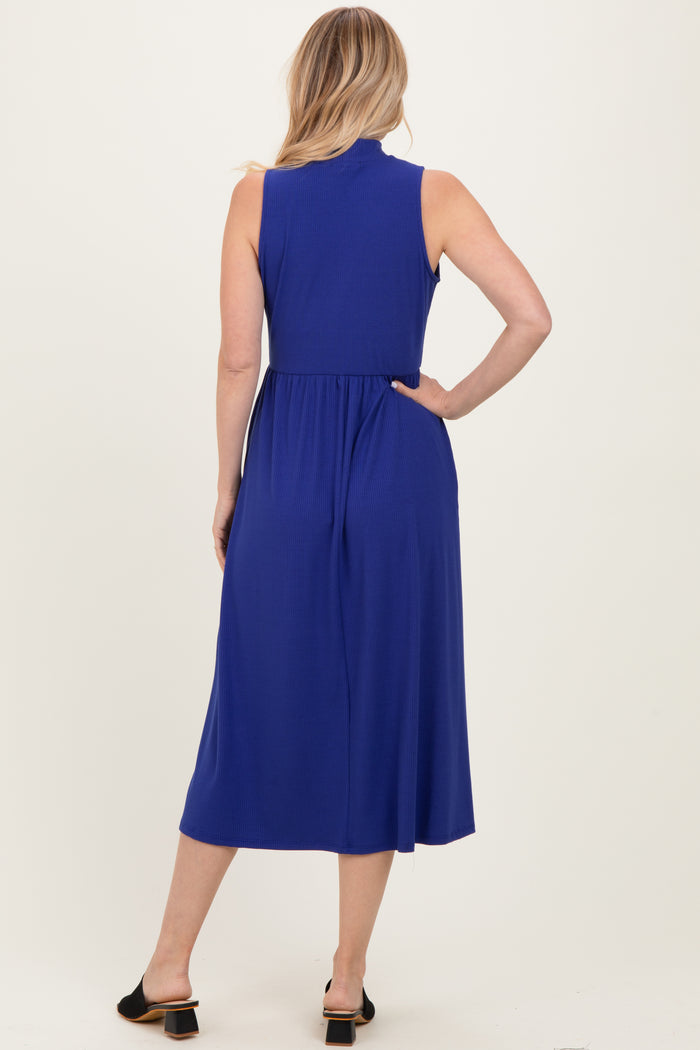 woman wearing a sleeveless royal blue midi dress with a cinched waist and a flowy skirt, viewed from the back
