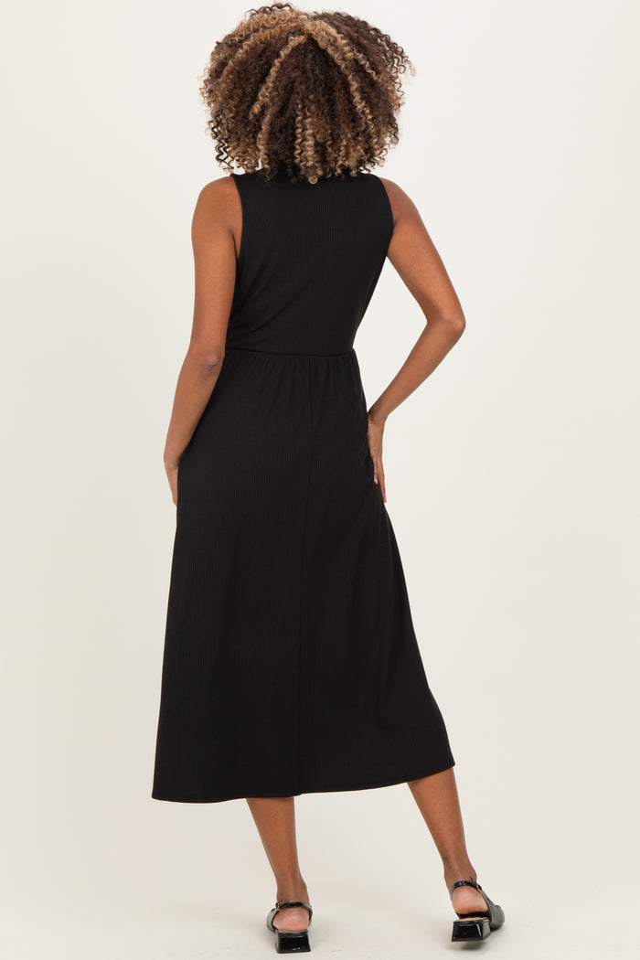 woman wearing a black sleeveless midi maternity dress, showing the back view