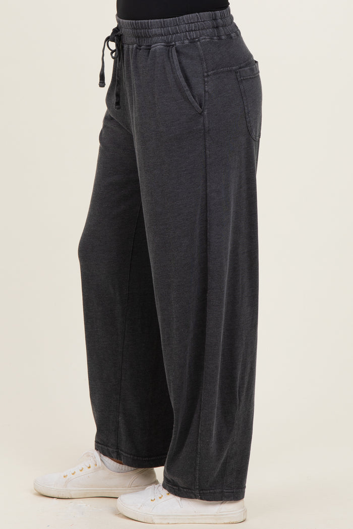 woman wearing relaxed fit charcoal gray wide-leg pants with an elastic waistband and side pockets